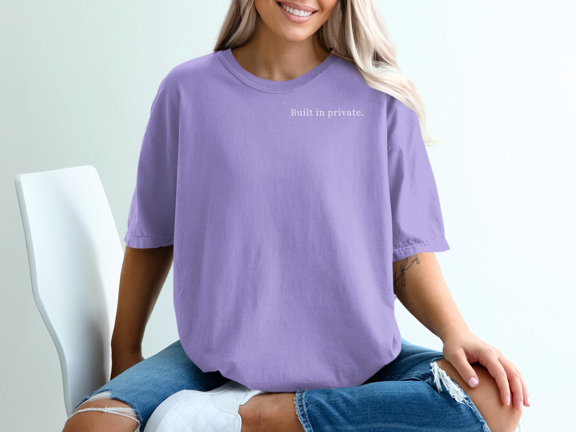 Purple t-shirt with "Built in private." text on the left chest.
