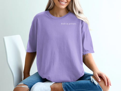 Purple t-shirt with "Built in private." text on the left chest.