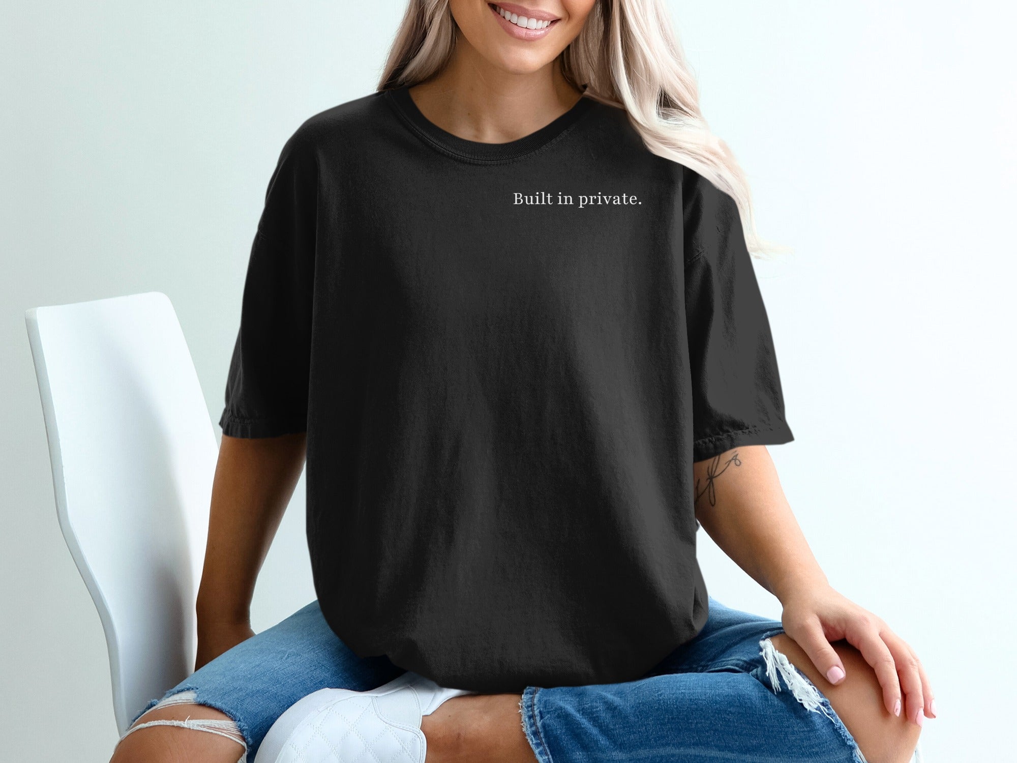 Black t-shirt with "Built in private." printed in white text.