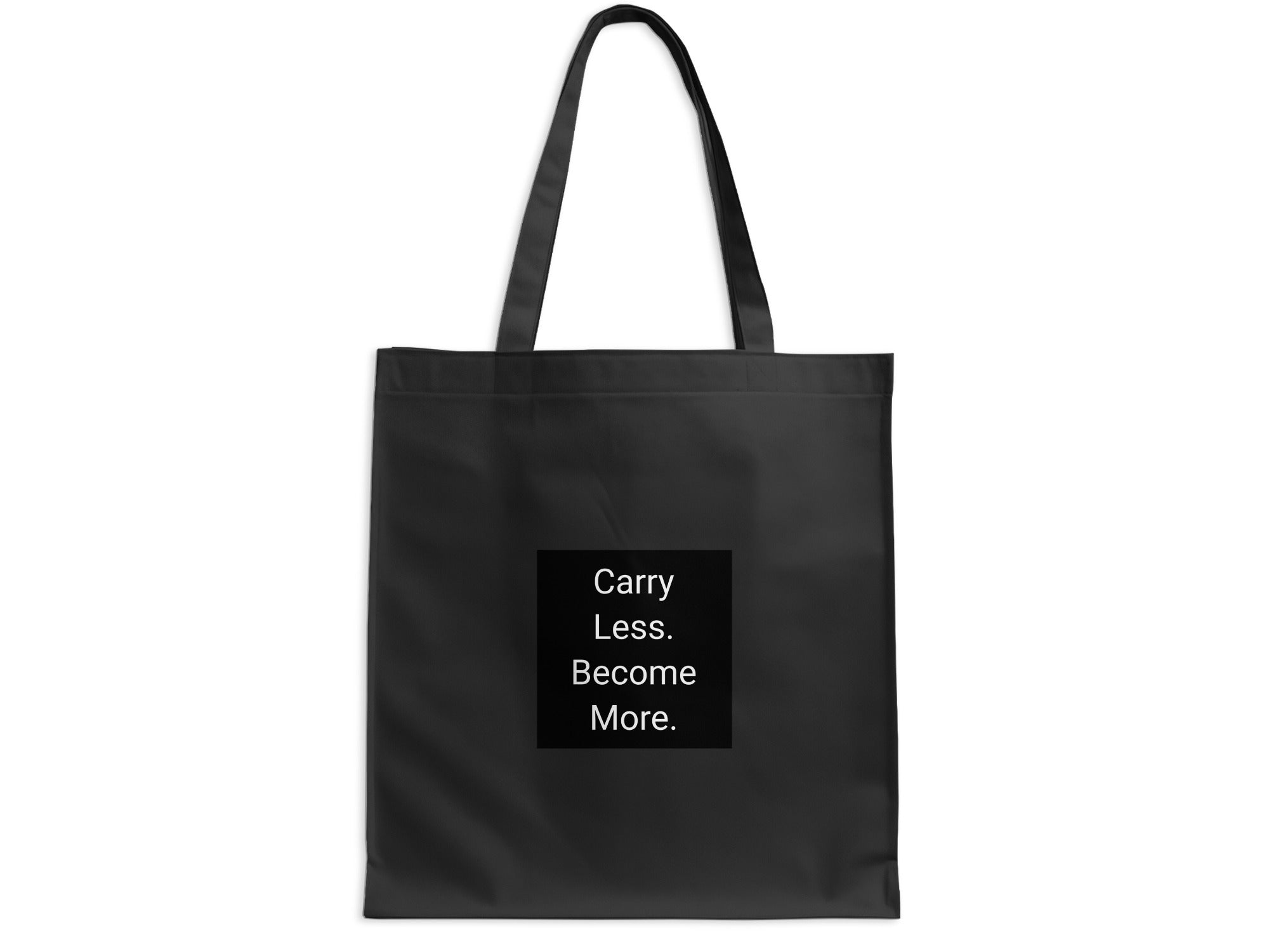 Black tote bag with text "Carry Less. Become More."