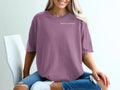 Woman wearing a plum colored t-shirt with "Built in private." text.